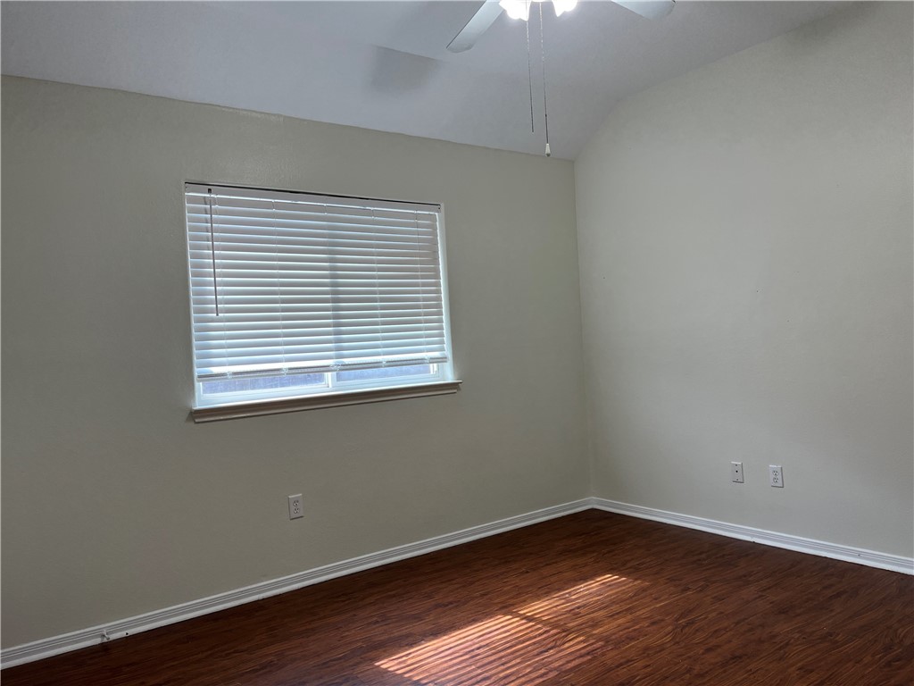 1406 Sacramento Street Portland, TX 78374 - Photo 26 of 35 an empty room with wooden floor and windows
