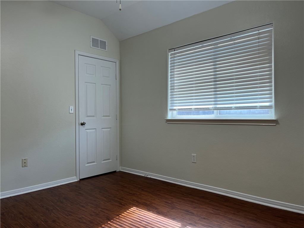 1406 Sacramento Street Portland, TX 78374 - Photo 27 of 35 an empty room with wooden floor and a window