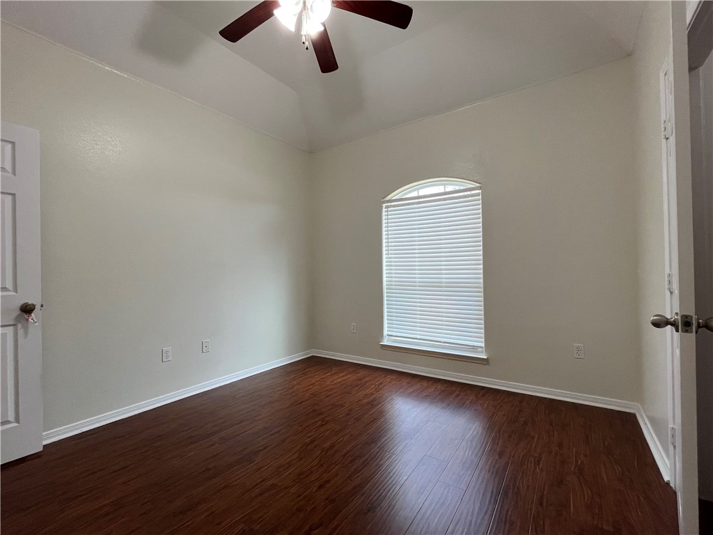 1406 Sacramento Street Portland, TX 78374 - Photo 30 of 35 an empty room with wooden floor chandelier fan and window