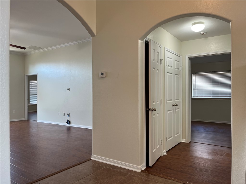 1406 Sacramento Street Portland, TX 78374 - Photo 32 of 35 an empty room with wooden floor and windows