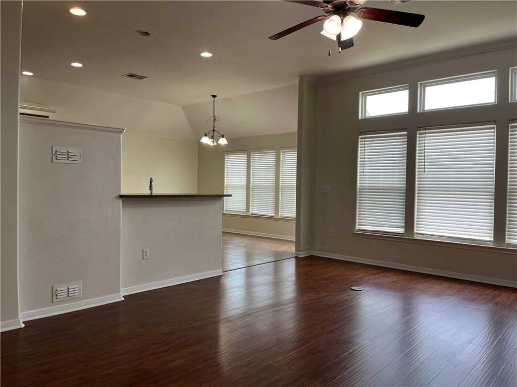 1406 Sacramento Street Portland, TX 78374 - Photo 9 of 35 an empty room with wooden floor and windows