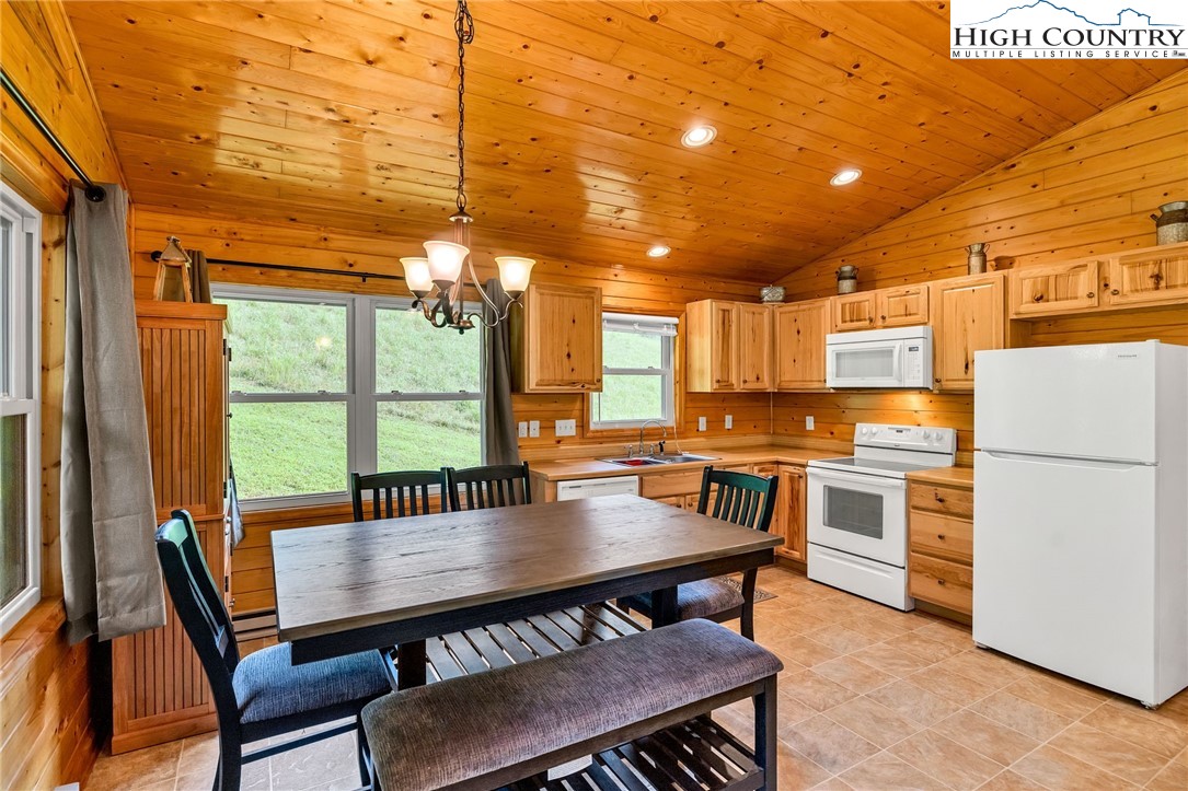 637 River Country Road Piney Creek, NC 28663 - Photo 13 of 49 a view of a dining room with furniture window and outside view