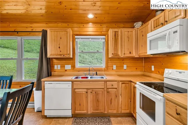 a kitchen with stainless steel appliances a stove a sink and a refrigerator