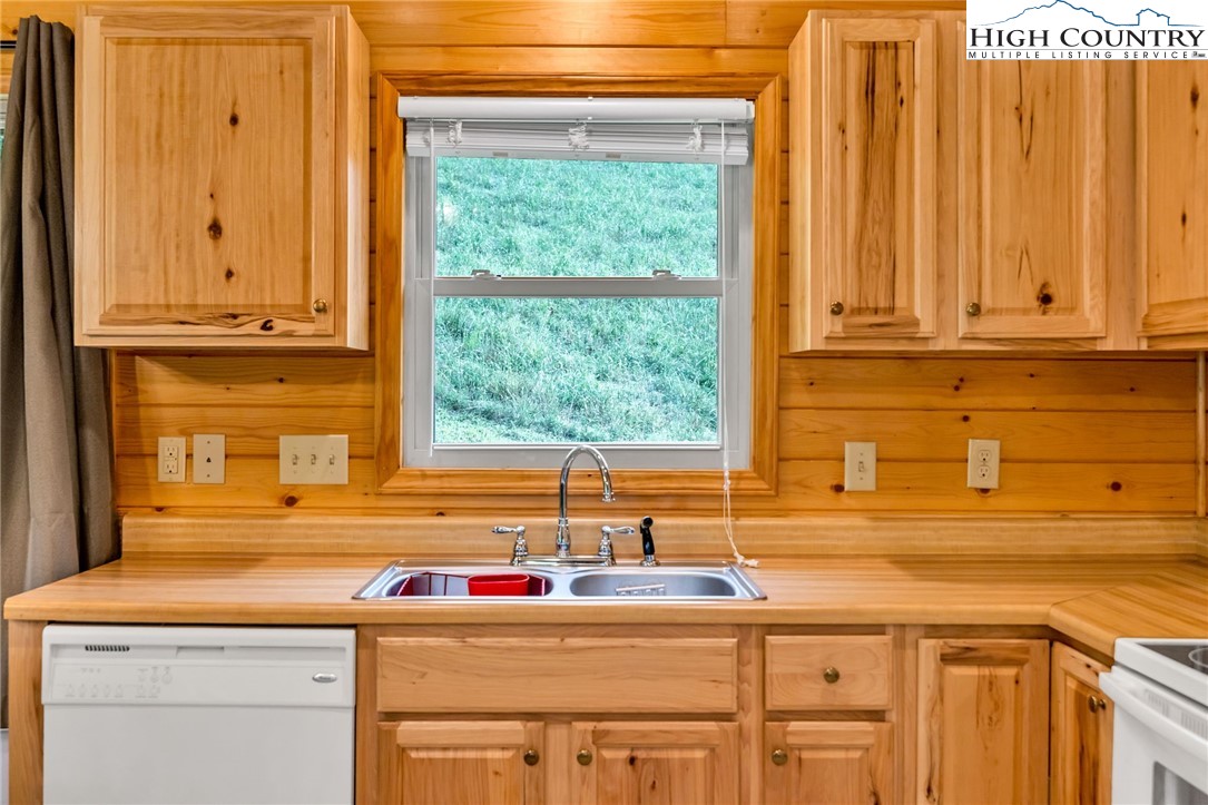637 River Country Road Piney Creek, NC 28663 - Photo 16 of 49 a kitchen with a sink and cabinets