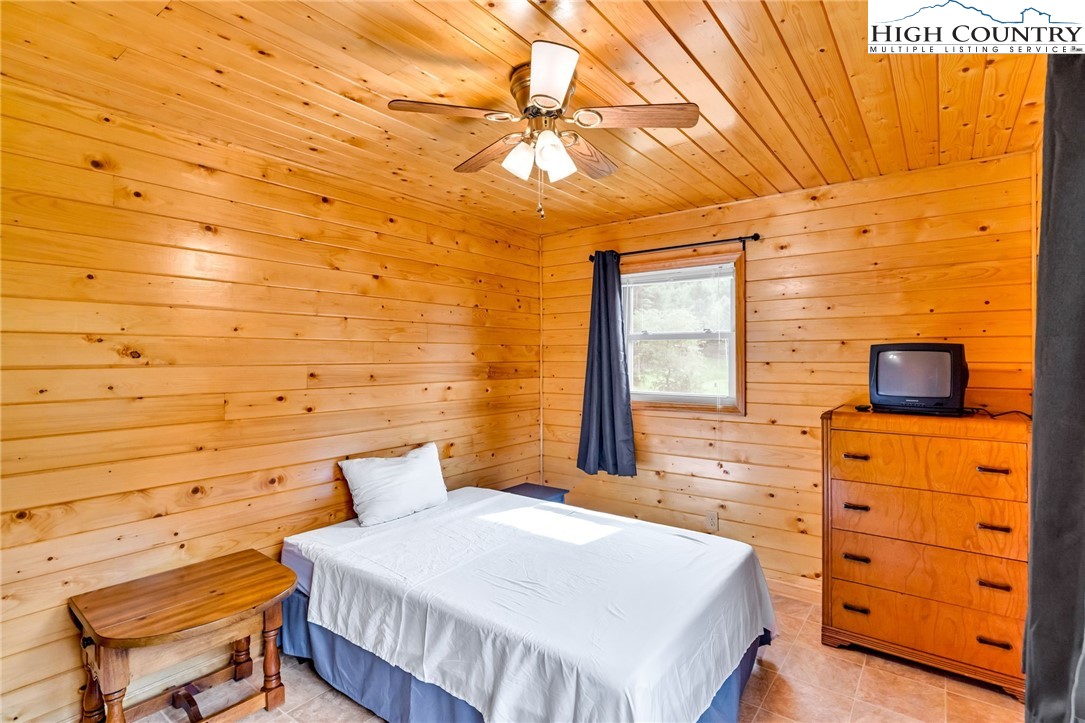 637 River Country Road Piney Creek, NC 28663 - Photo 21 of 49 a bedroom with a bed and a dresser