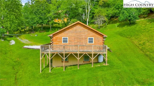 a view of an house with backyard space and a lake view