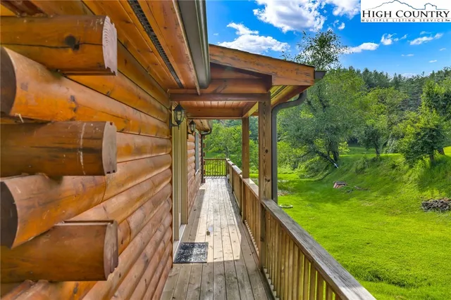 a view of balcony with wooden floor and fence