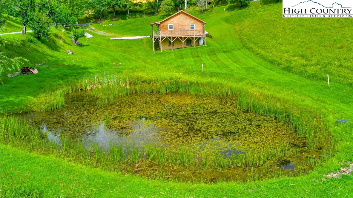 637 River Country Road Piney Creek, NC 28663 - Photo 30 of 49 a backyard of a house with lots of green space and plants