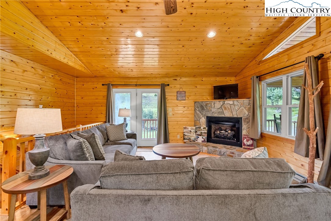 637 River Country Road Piney Creek, NC 28663 - Photo 3 of 49 a living room with furniture and a fireplace