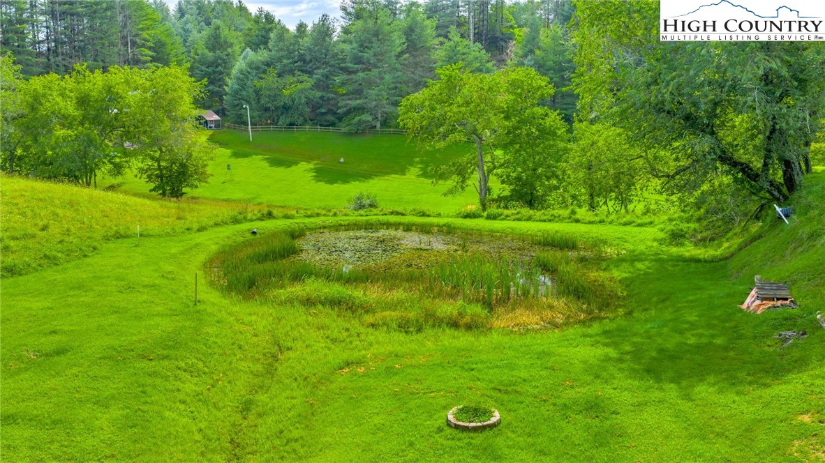 637 River Country Road Piney Creek, NC 28663 - Photo 38 of 49 a view of a golf course with a garden