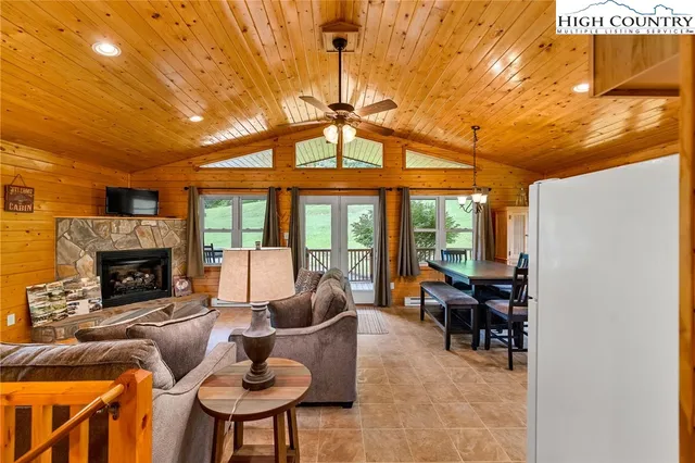 a living room with furniture a fireplace and a table