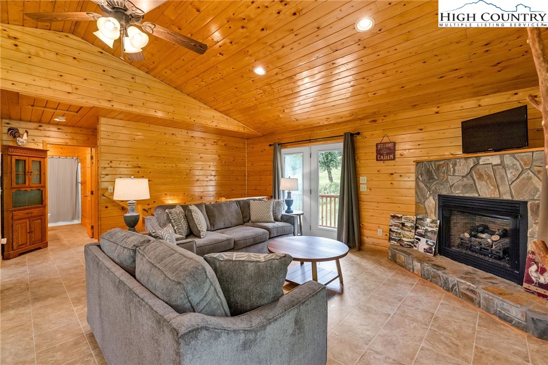 637 River Country Road Piney Creek, NC 28663 - Photo 9 of 49 a living room with furniture and a fireplace