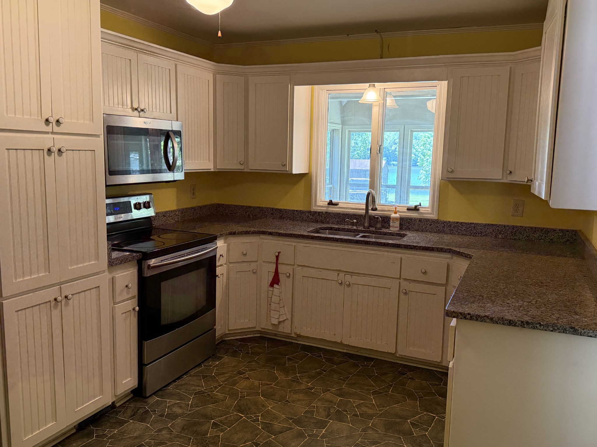 1419 Dripping Springs Road Winchester, TN 37398 - Photo 11 of 24 a kitchen with granite countertop cabinets stainless steel appliances a sink and a window
