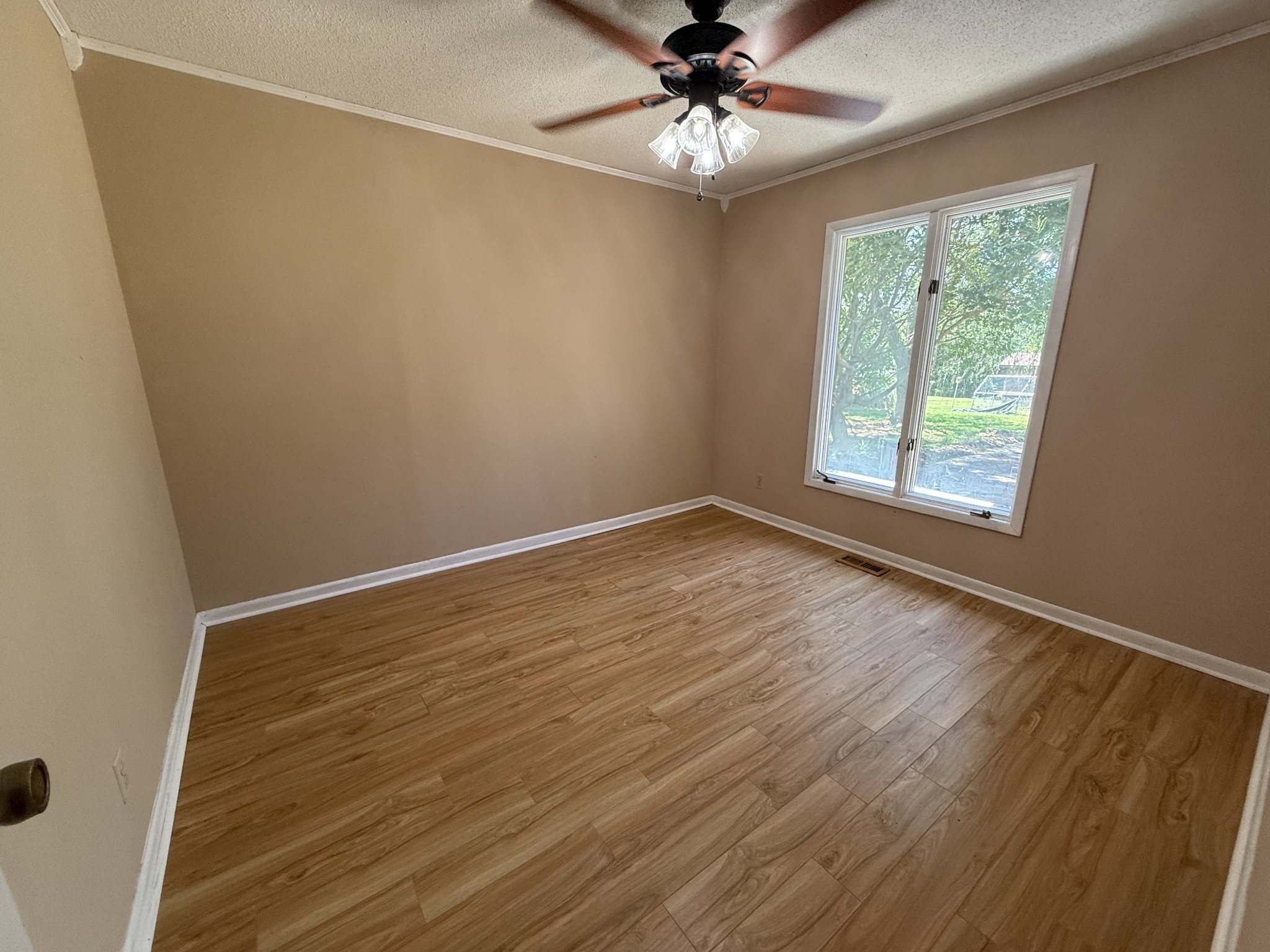 1419 Dripping Springs Road Winchester, TN 37398 - Photo 7 of 24 a view of an empty room with wooden floor and a window