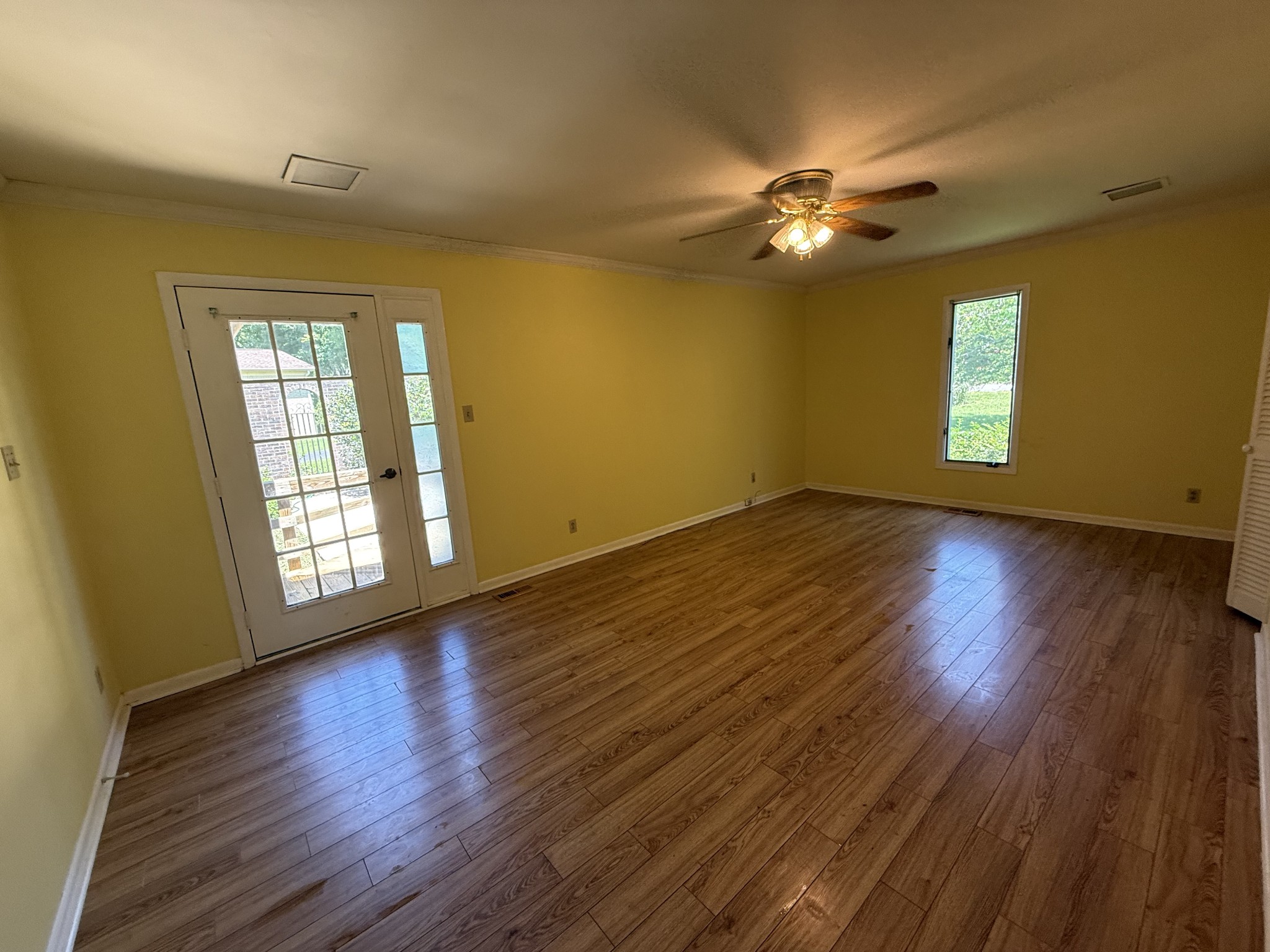 1419 Dripping Springs Road Winchester, TN 37398 - Photo 9 of 24 a view of an empty room with wooden floor and a window