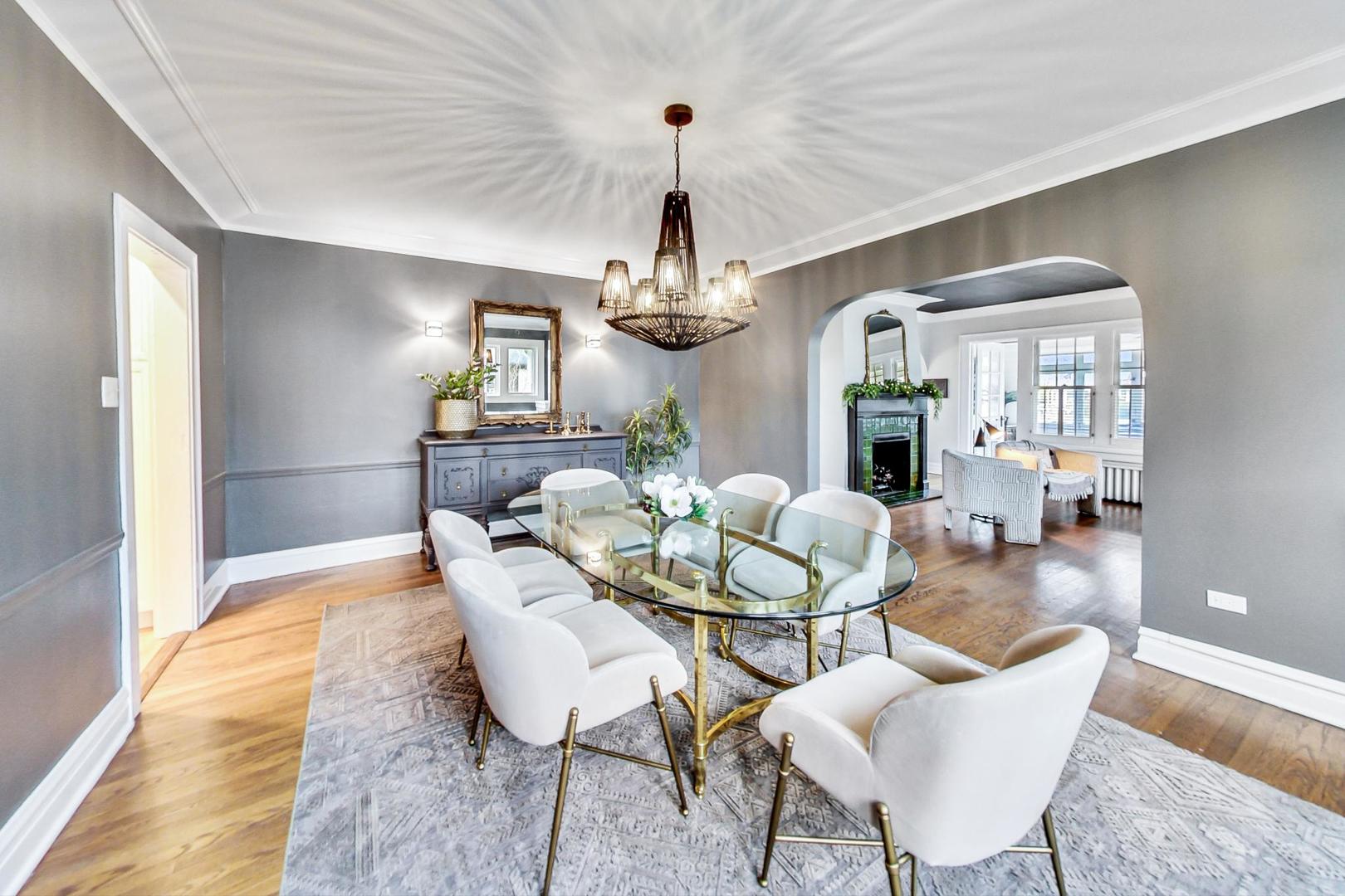 165 South Delaplaine Road Riverside, IL 60546 - Photo 13 of 51 a dining room with wooden floor a chandelier a wooden table and chairs
