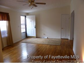384 Tc Jones Road Raeford, NC 28376 - Photo 5 of 12 wooden floor in an empty room with a window