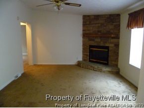 384 Tc Jones Road Raeford, NC 28376 - Photo 8 of 12 a view of an empty room with a fireplace and a window