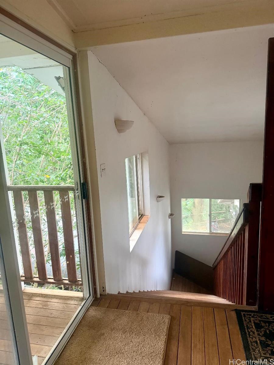 59-543 Alapio Road Haleiwa, HI 96712 - Photo 12 of 20 a view of a livingroom with wooden floor and windows