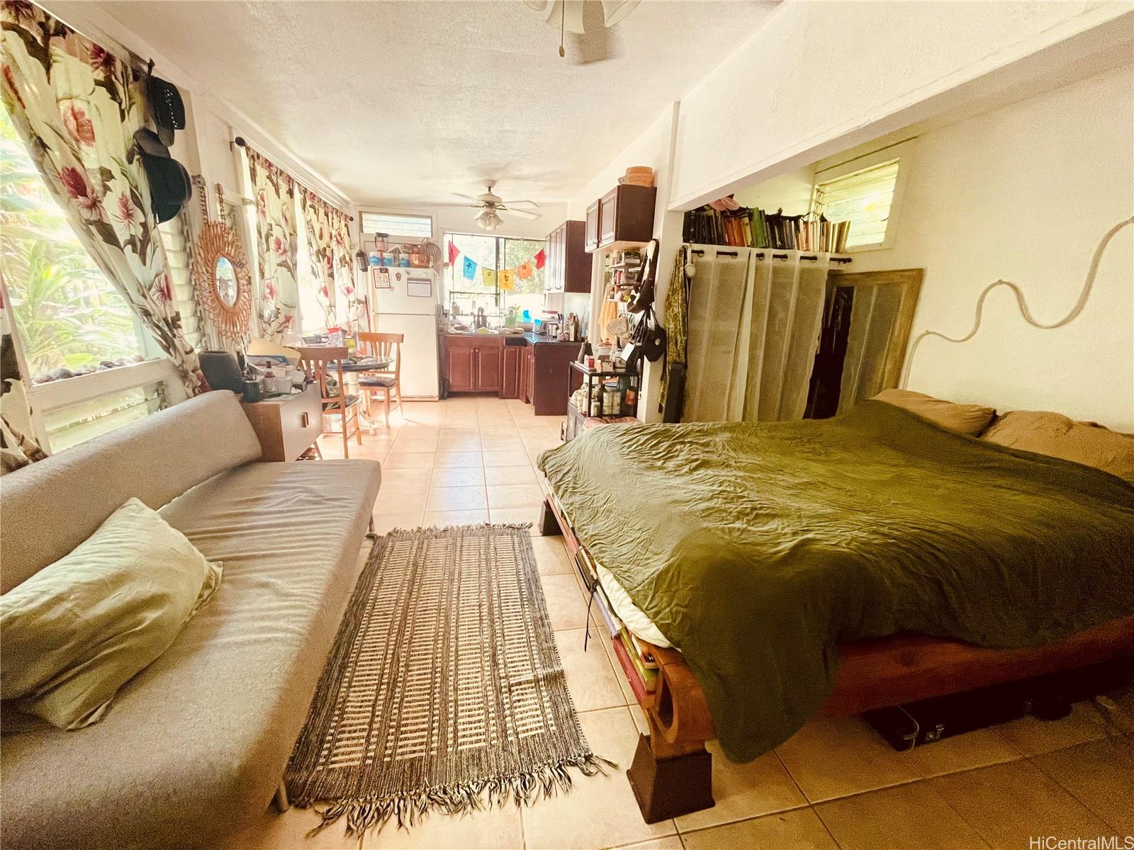 59-543 Alapio Road Haleiwa, HI 96712 - Photo 17 of 20 a bed sitting in a bedroom next to a window