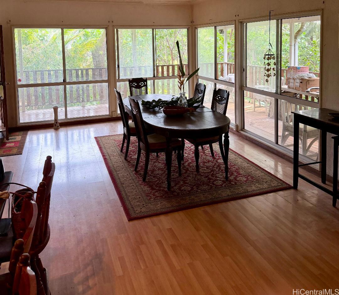 59-543 Alapio Road Haleiwa, HI 96712 - Photo 9 of 20 a view of a dining room with furniture window and wooden floor