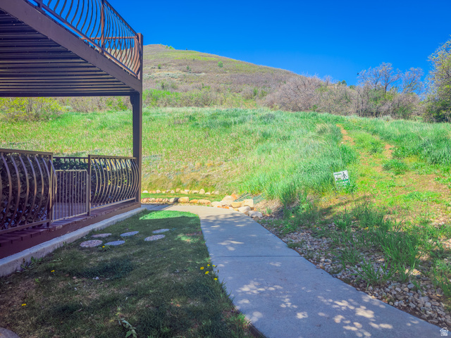 1041 West Grindelwald Court, Unit R5 Midway, UT 84049 - Photo 2 of 44 Ground-level patio with decorative metal railing and concrete walkway