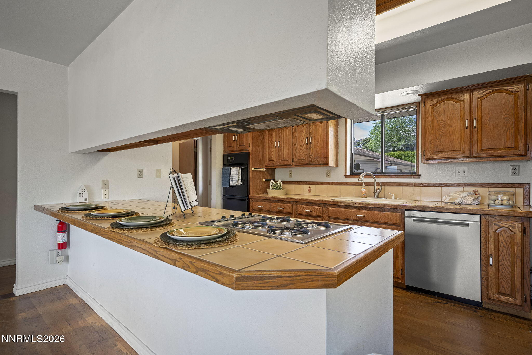 2985 Socrates Drive Reno, NV 89512 - Photo 41 of 52 a kitchen with stainless steel appliances granite countertop a sink a stove and a wooden cabinets