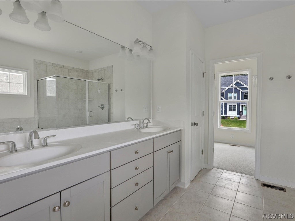 11673 Riverboat Drive Chester, VA 23836 - Photo 12 of 23 a spacious bathroom with a granite countertop sink mirror and bathtub