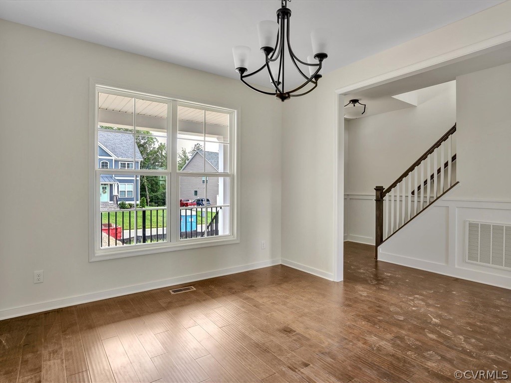 11673 Riverboat Drive Chester, VA 23836 - Photo 3 of 23 a view of an empty room with wooden floor and fan