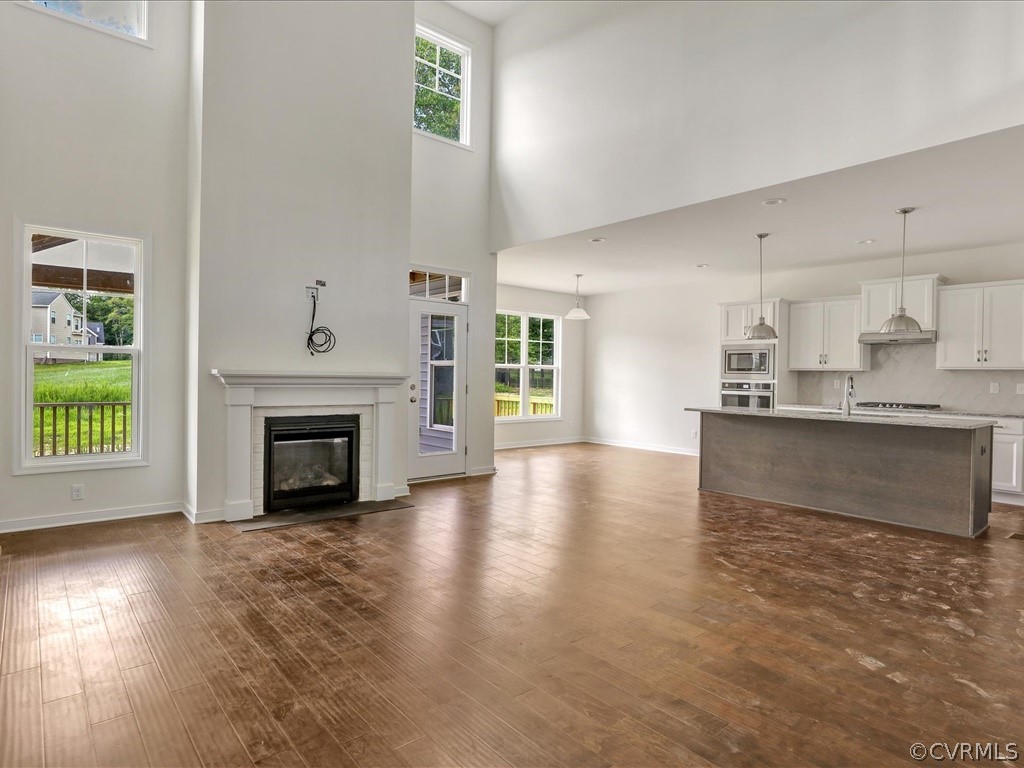 11673 Riverboat Drive Chester, VA 23836 - Photo 4 of 23 a view of an empty room with a kitchen and a fireplace