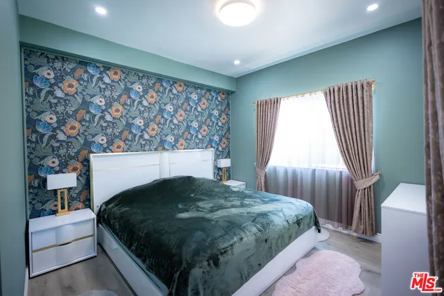 a en suite bathroom with a granite countertop sink and a mirror