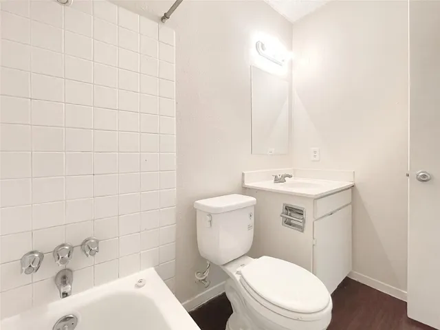 a white toilet sitting next to a bathroom sink