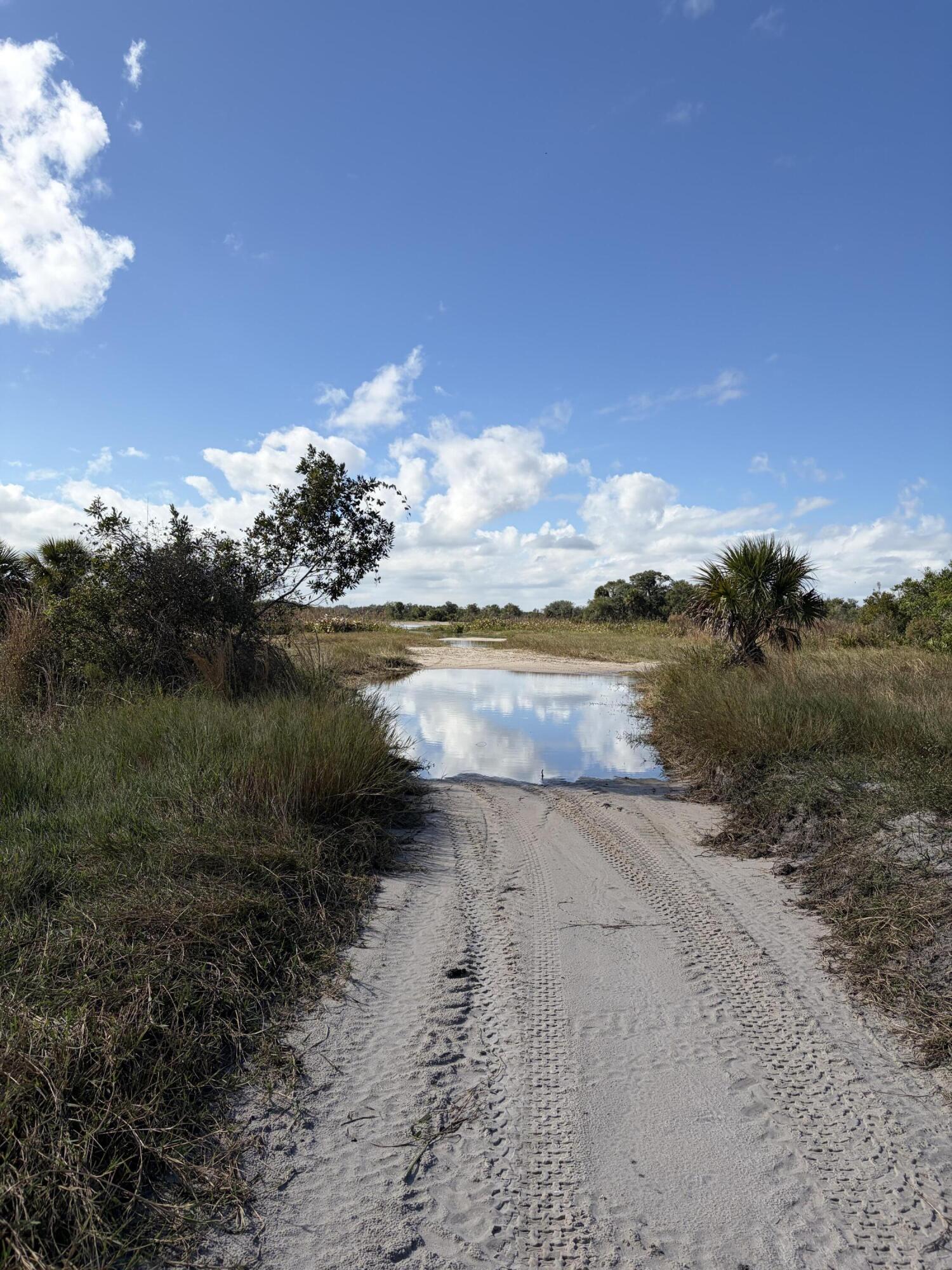 0 Northwest 308th Street Okeechobee, FL 34972 - Photo 5 of 7 a view of a lake with beach in background