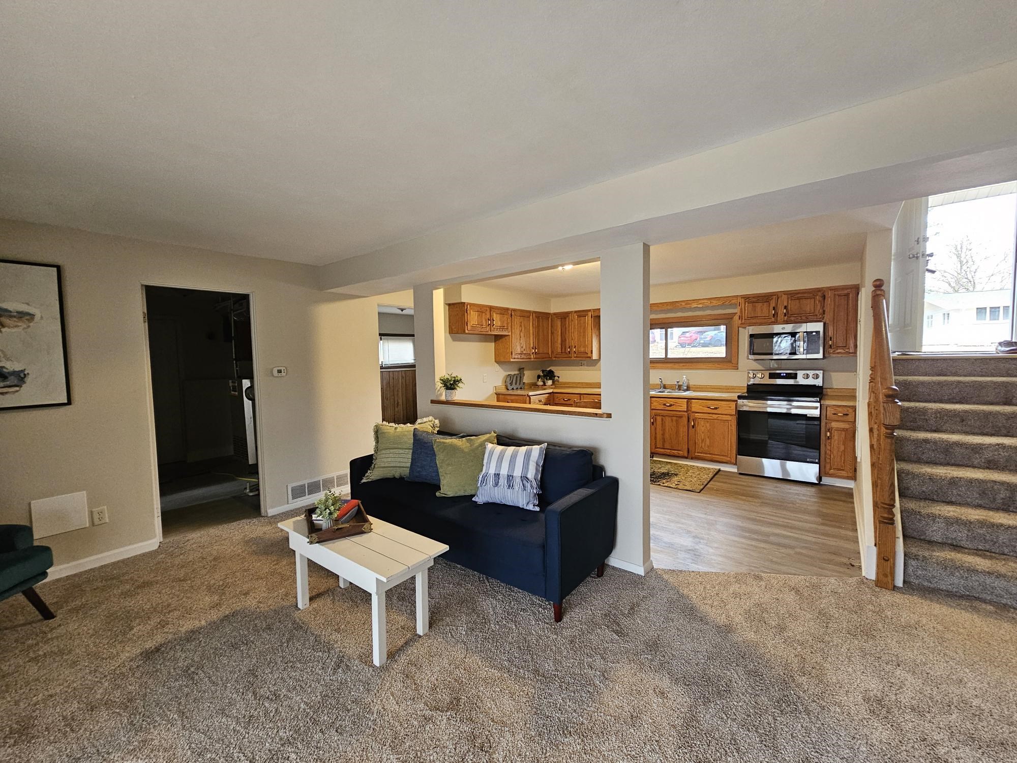 808 Crest View Trail Byron, IL 61010 - Photo 4 of 18 a living room with furniture and a kitchen view