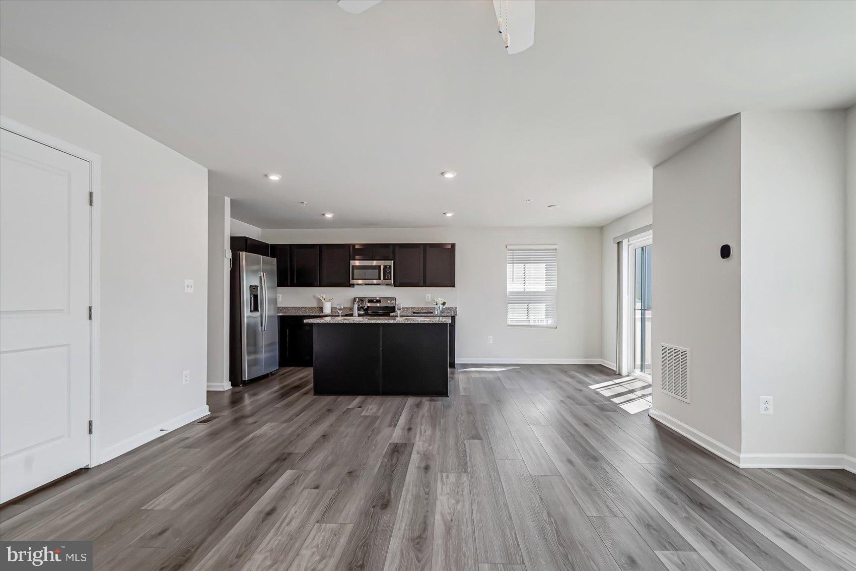 43 Olive Way Elkton, MD 21921 - Photo 11 of 44 a view of kitchen with sink microwave refrigerator and stove