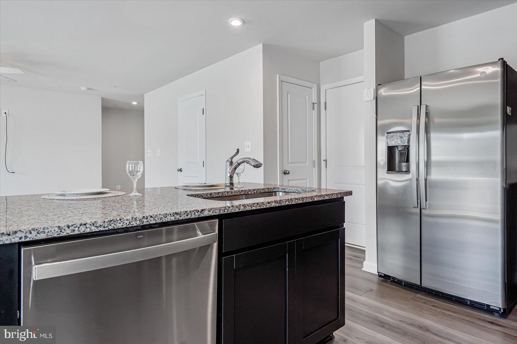 43 Olive Way Elkton, MD 21921 - Photo 16 of 44 a kitchen with granite countertop stainless steel appliances a sink and a refrigerator