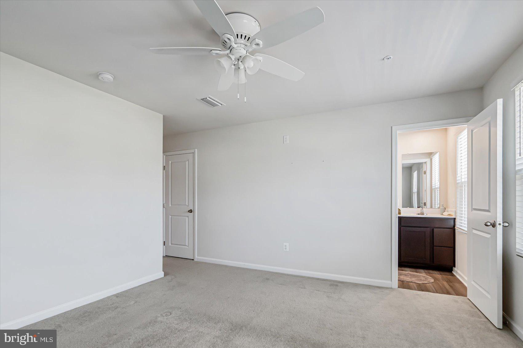 43 Olive Way Elkton, MD 21921 - Photo 24 of 44 an empty room with windows and ceiling fan