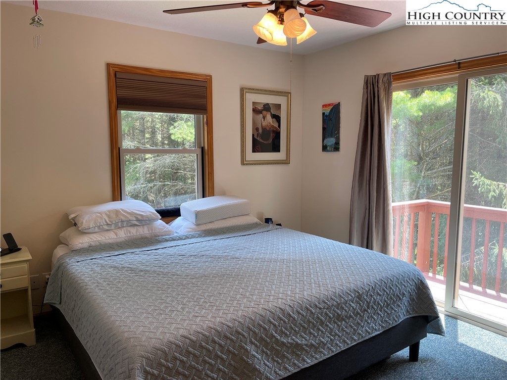 219 Lucky Alice Road Grassy Creek, NC 28631 - Photo 13 of 40 a bedroom with a large bed and a window