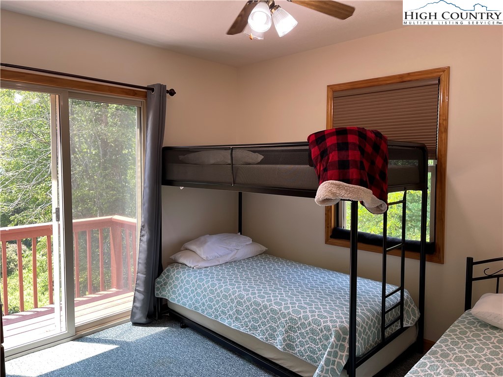 219 Lucky Alice Road Grassy Creek, NC 28631 - Photo 17 of 40 a bedroom with a bed a window and lamp