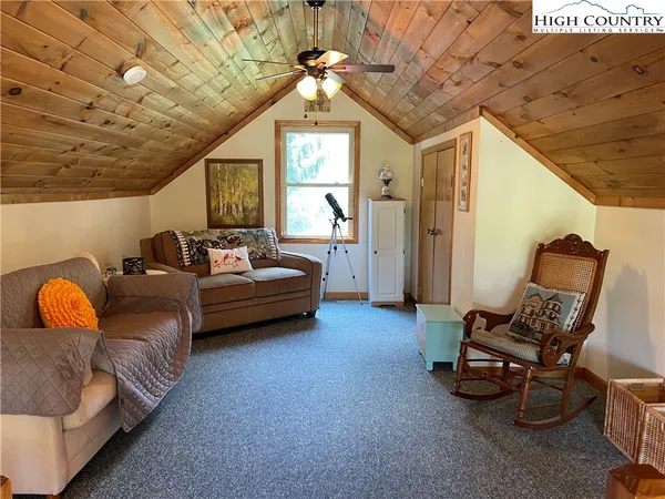 a bedroom with furniture and a ceiling fan