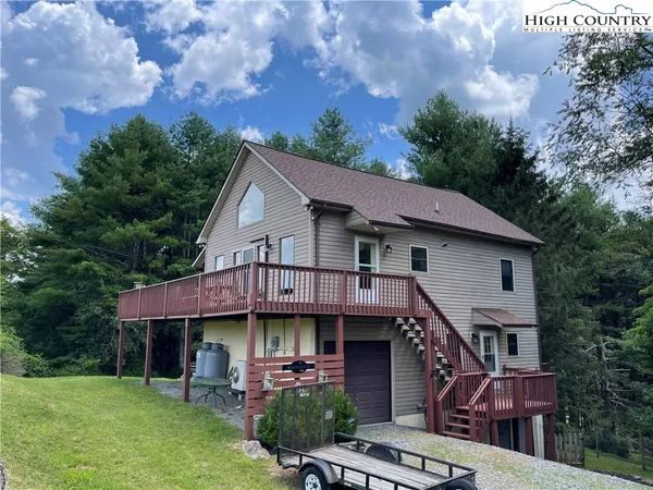 a aerial view of a house with roof deck front of house