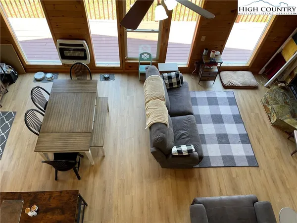 a living room with furniture and a floor to ceiling window