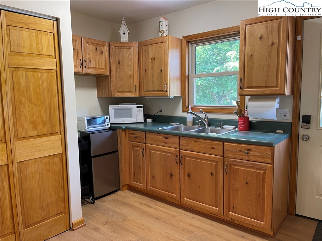 219 Lucky Alice Road Grassy Creek, NC 28631 - Photo 27 of 40 a kitchen with stainless steel appliances granite countertop a refrigerator sink and cabinets