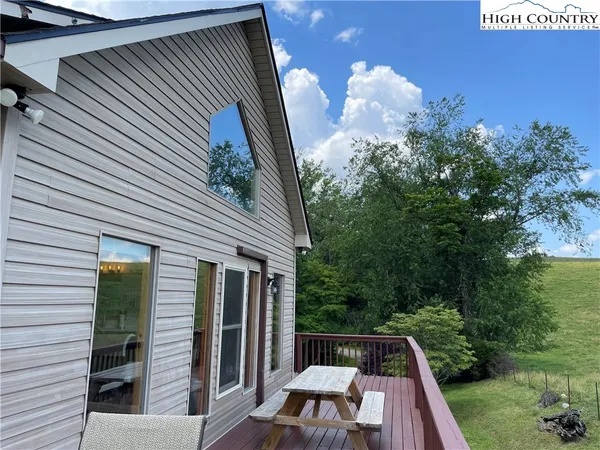 a view of backyard with swimming pool and outdoor seating