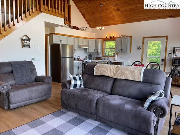 a living room with furniture ceiling fan and a window