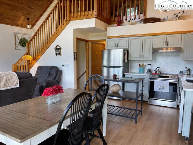 a dining room with furniture and wooden floor