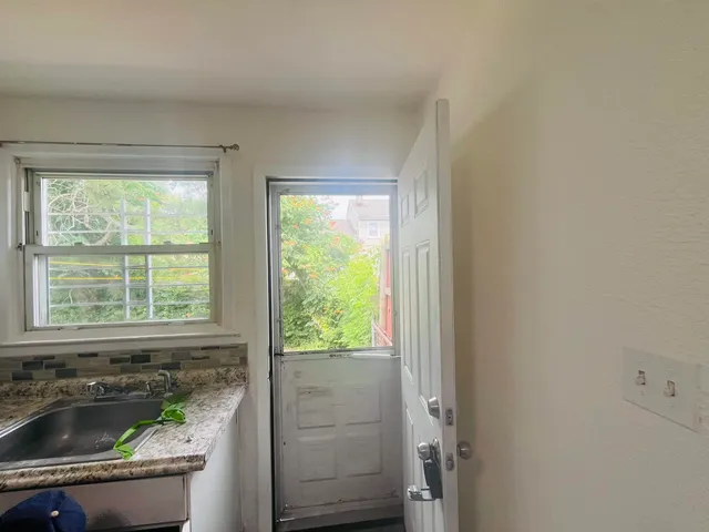 a bath tub sitting in a bathroom next to a window