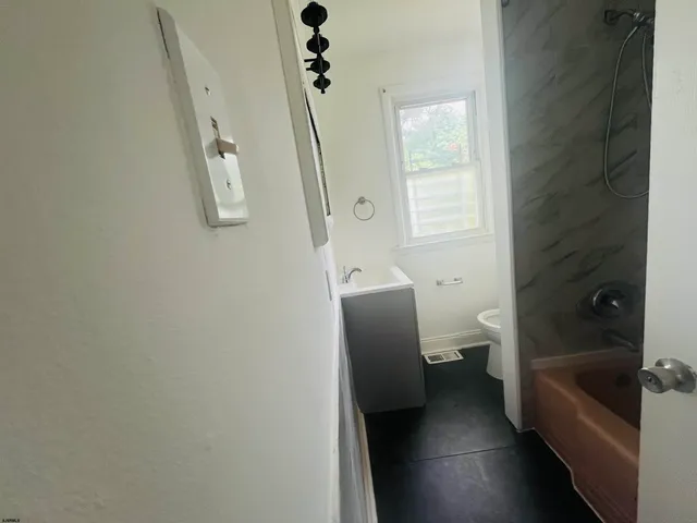 a white toilet sitting next to a window