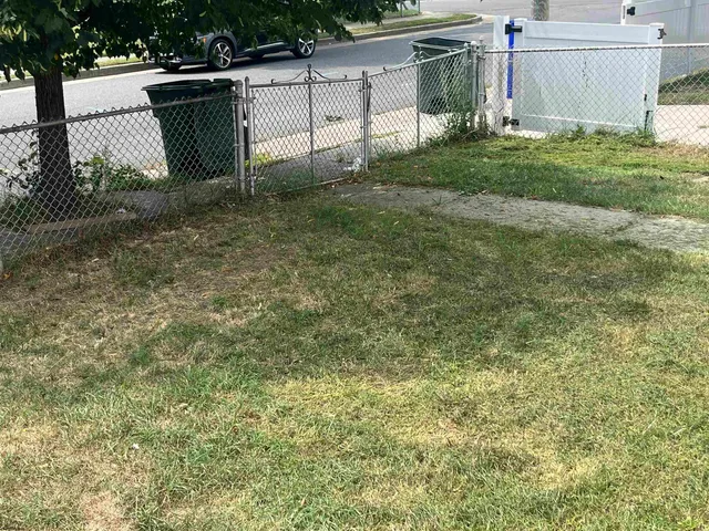 a view of a house with a yard and a garden