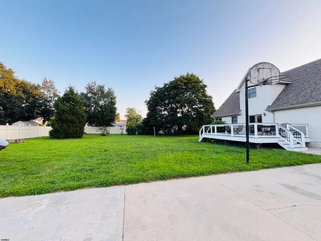 a view of small wooden house with a small yard